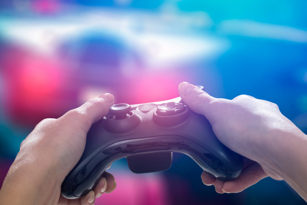 A Man holding the gaming gear in a blur background.